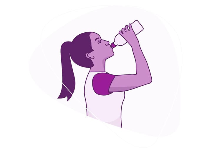A woman drinking water from a water bottle
